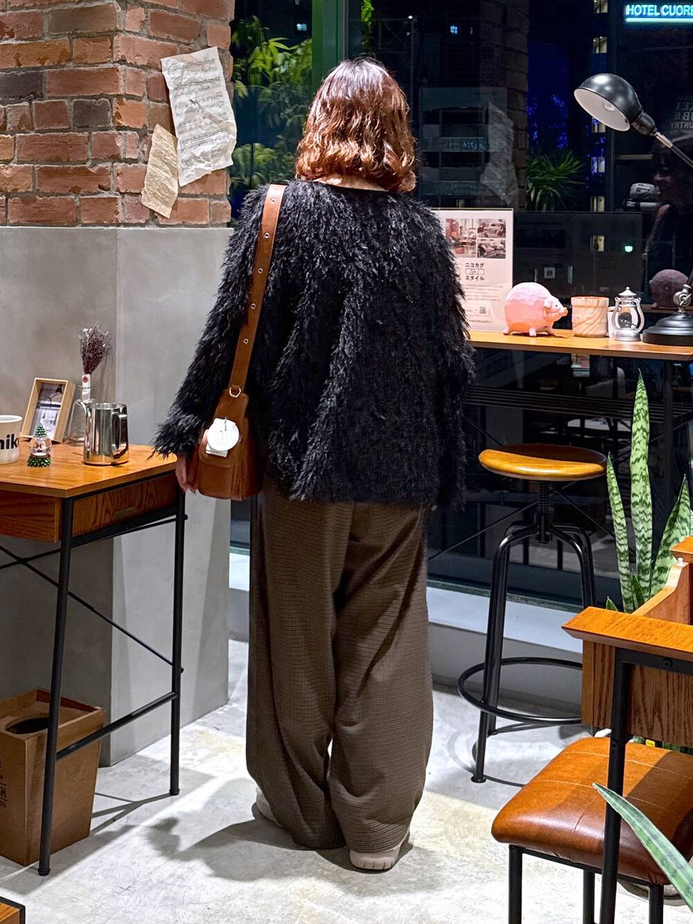 ブラウン系のその他パンツ、ベージュ系のスリッポン、ブラック系のその他トップスを着用したレディースの冬コーディネートの6枚目の写真