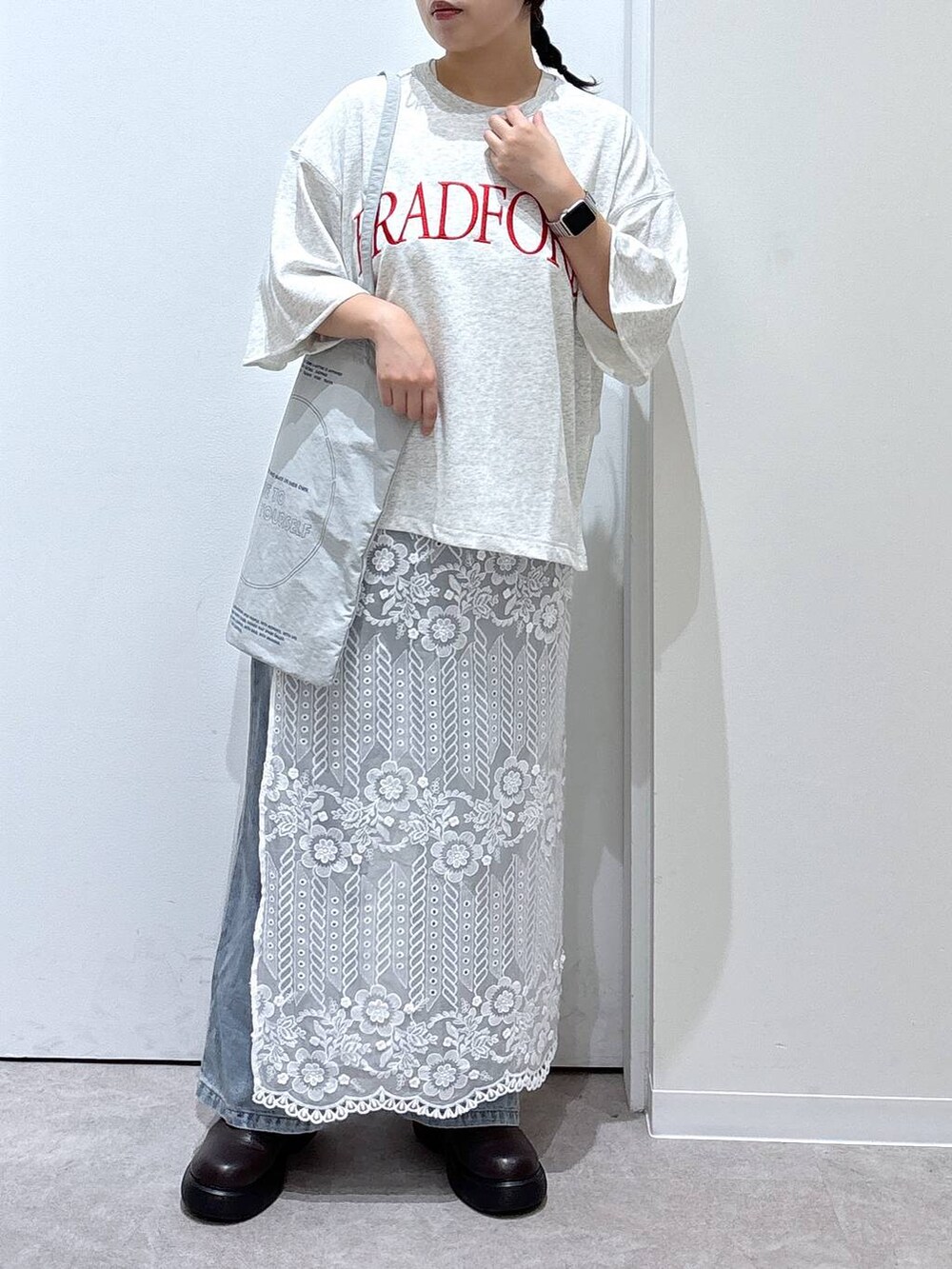 ブルー系のデニムパンツ、グレー系のトートバッグ、その他のストール/ショールを着用したレディースの秋コーディネートの4枚目の写真