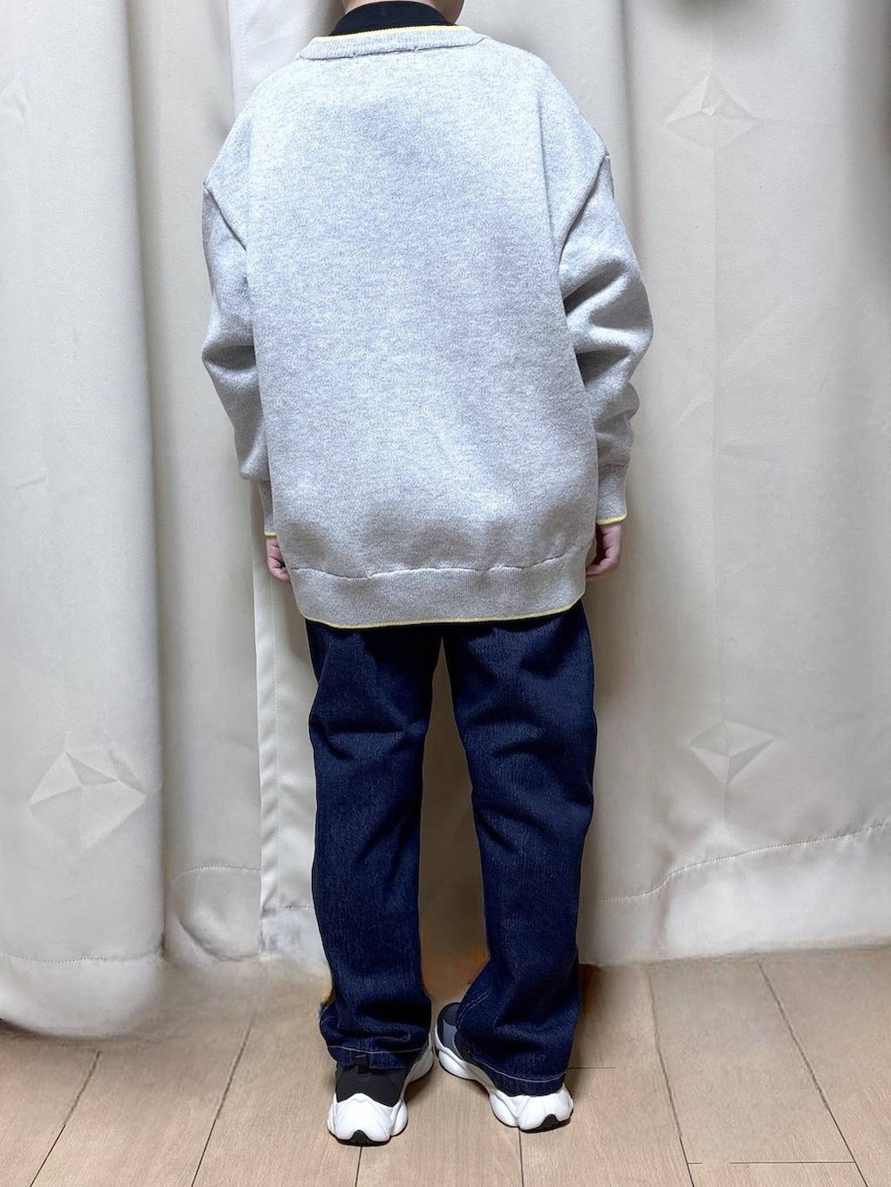 ブラック系のスニーカー、ブルー系のデニムパンツ、ブラック系のTシャツ/カットソーを着用したキッズの冬コーディネートの3枚目の写真