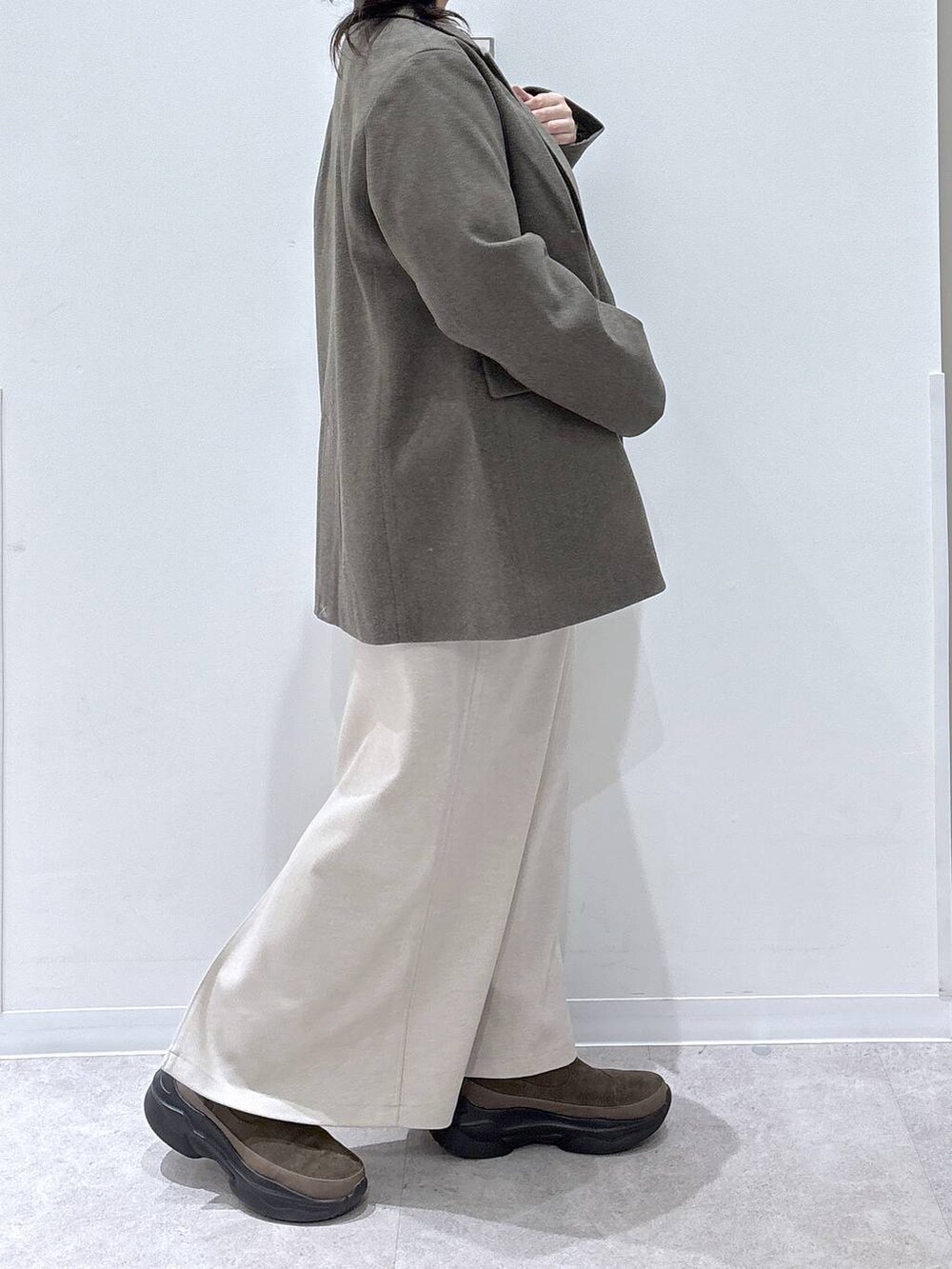 ブラウン系のブーツ、ホワイト系のスカートを着用したレディースの秋コーディネートの2枚目の写真