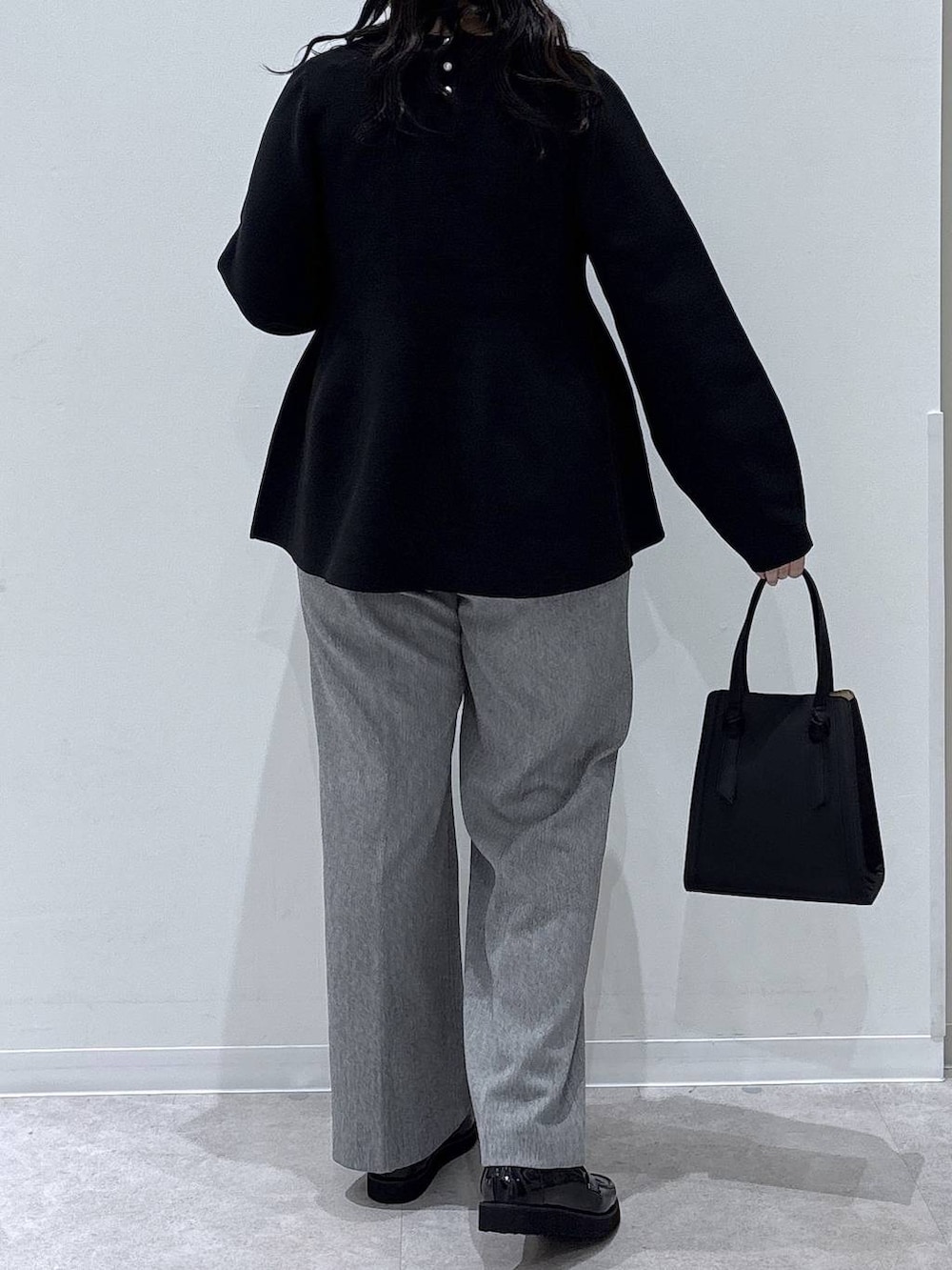 ブラック系のローファー、ブラック系のショルダーバッグ、グレー系のその他パンツを着用したレディースの冬コーディネートの3枚目の写真