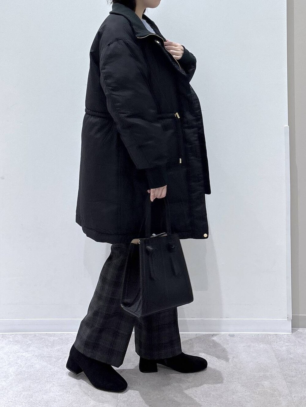 ブラック系のショルダーバッグ、ブラック系のダウンジャケット/コート、ブラック系のその他パンツを着用したレディースの秋コーディネートの2枚目の写真