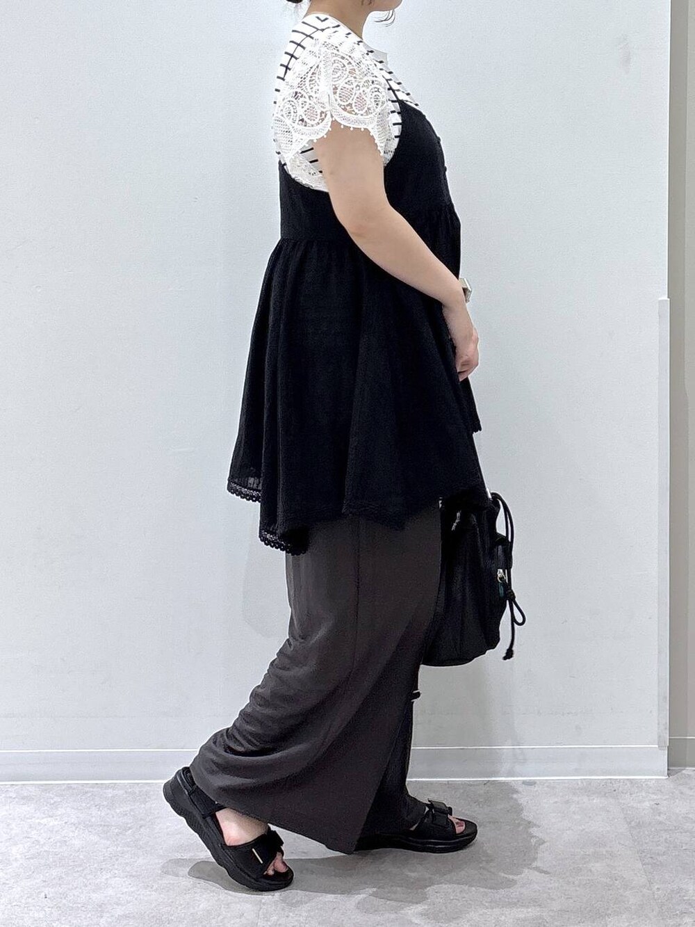 ブラック系のシャツ/ブラウス、ブラック系のサンダル、ホワイト系のTシャツ/カットソーを着用したレディースの夏コーディネートの2枚目の写真