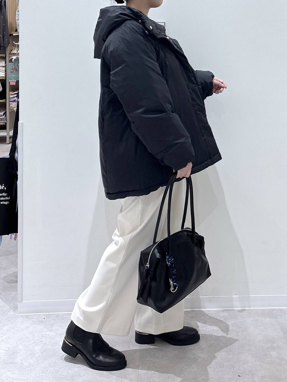 ブルー系のダウンジャケット/コート、ブラック系のボストンバッグ、グレー系のその他パンツを着用したレディースの秋コーディネートの2枚目の写真