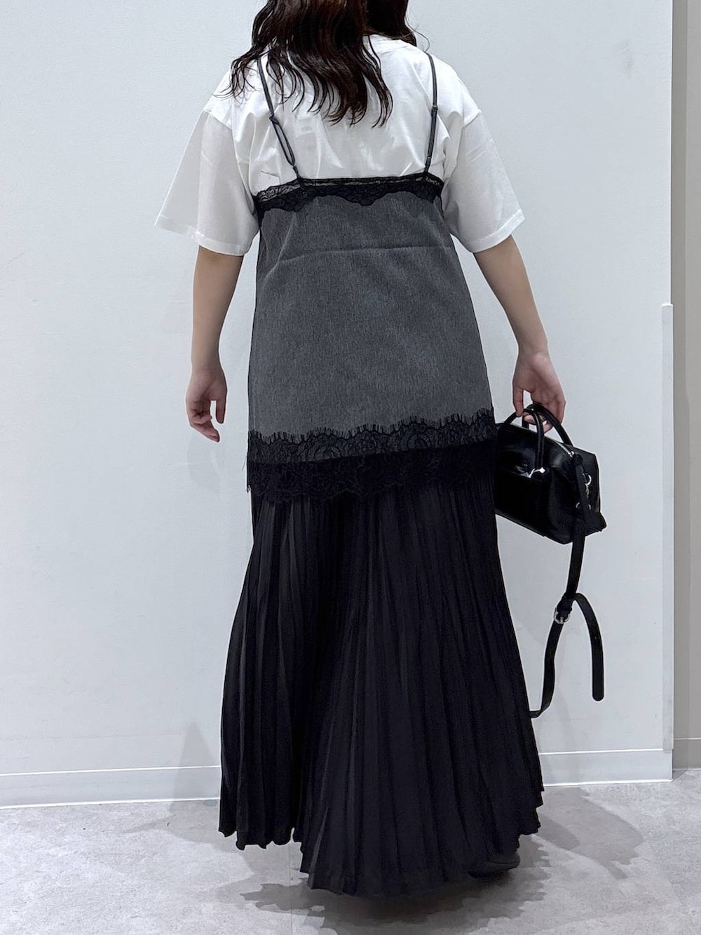 グレー系のスカート、ブラック系のバレエシューズ、ホワイト系のTシャツ/カットソーを着用したレディースの夏コーディネートの3枚目の写真