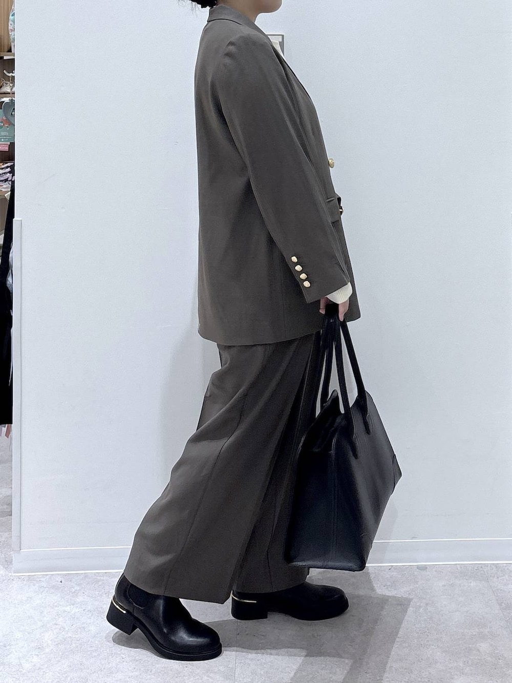 ブラック系のトートバッグ、ベージュ系のテーラードジャケット、ベージュ系のその他パンツを着用したレディースの秋コーディネートの2枚目の写真