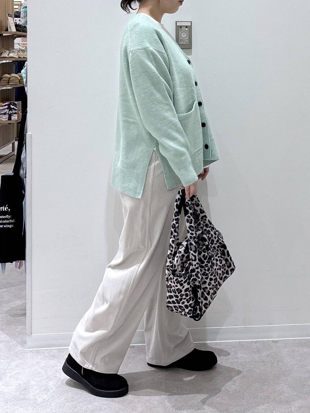 その他のトートバッグ、グリーン系のカーディガン/ボレロ、グレー系のその他パンツを着用したレディースの秋コーディネートの2枚目の写真