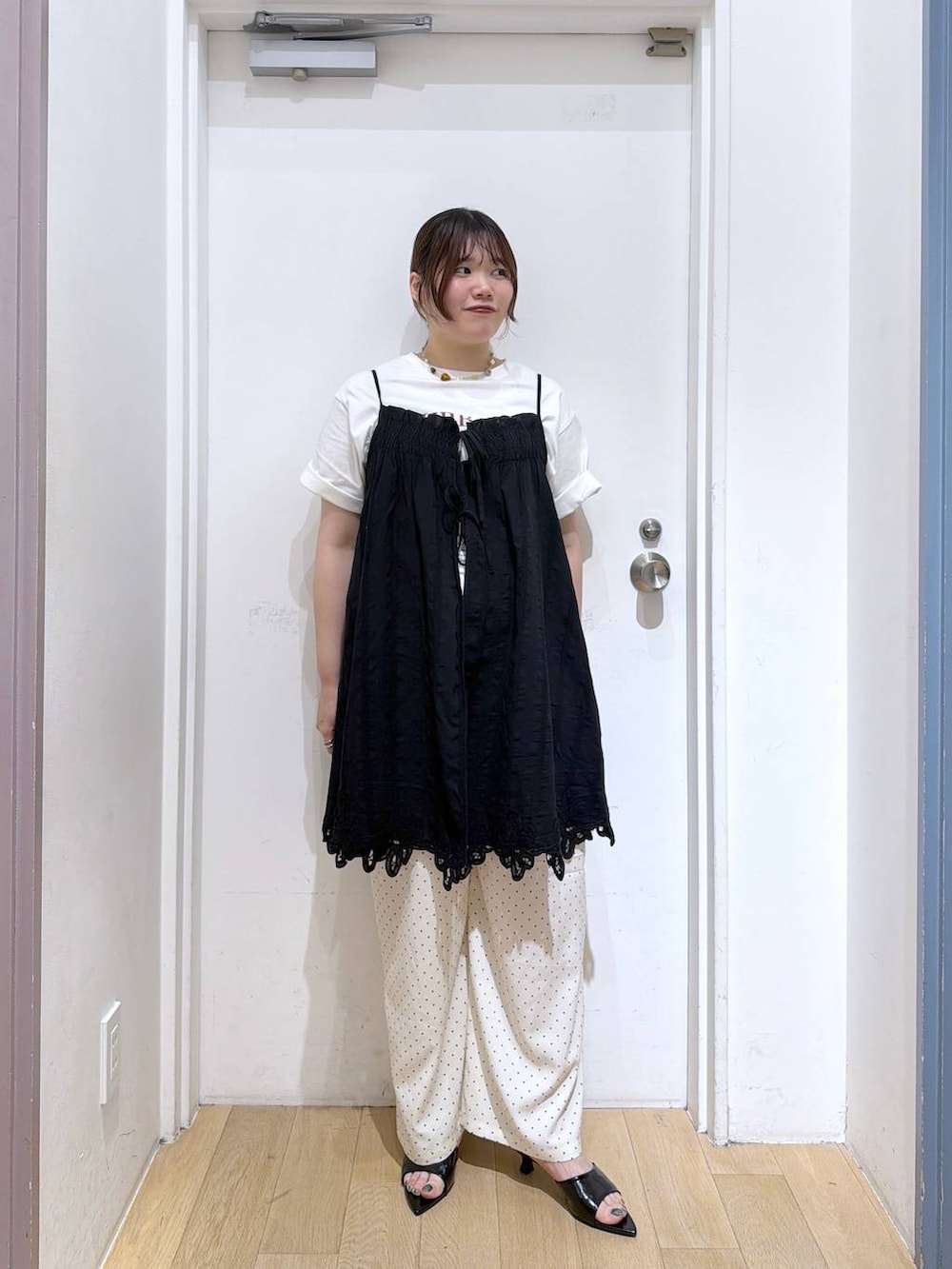 ブラック系のワンピース、ホワイト系のその他パンツ、ブラック系のサンダルを着用したレディースの夏コーディネートの2枚目の写真