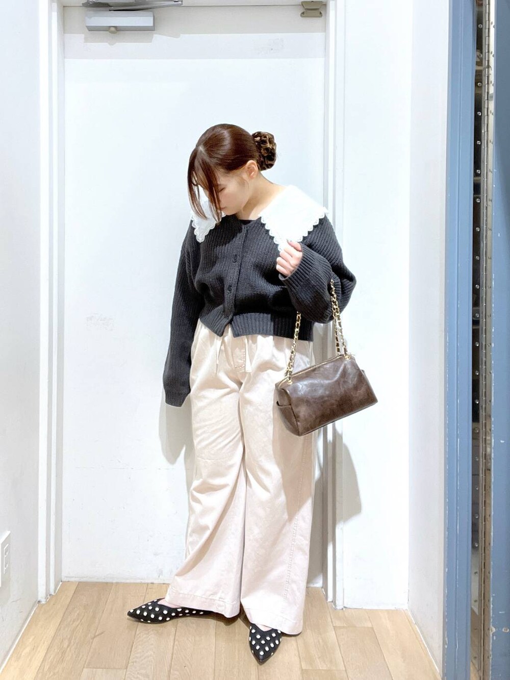 ピンク系のデニムパンツ、ブラウン系のショルダーバッグ、その他のパンプスを着用したレディースの冬コーディネートの2枚目の写真