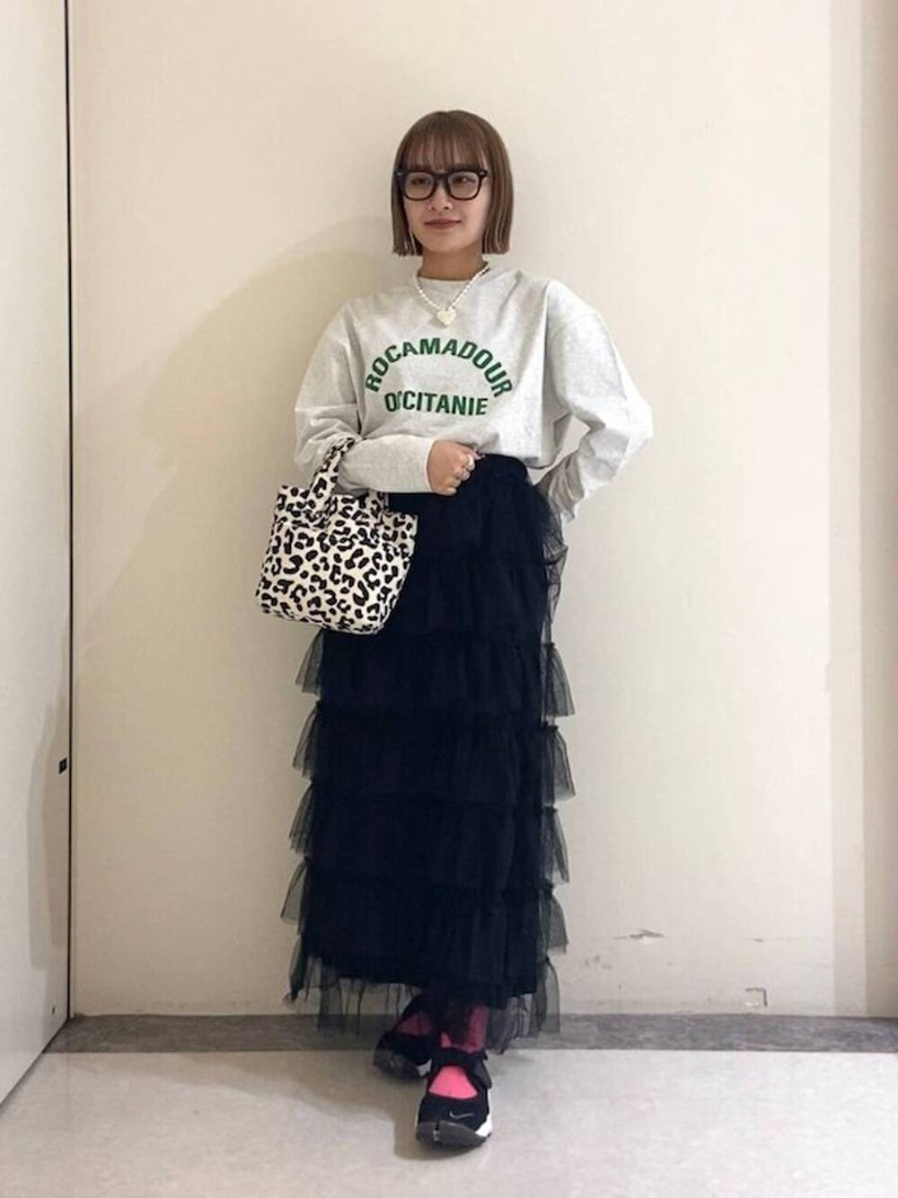 ブラック系のトートバッグ、ブラック系のスカート、グレー系のTシャツ/カットソーを着用したレディースの冬コーディネートの3枚目の写真