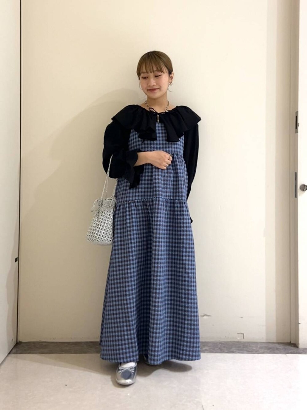 ブルー系のワンピース、シルバー系のバレエシューズ、ブラック系のシャツ/ブラウスを着用したレディースの春コーディネートの2枚目の写真