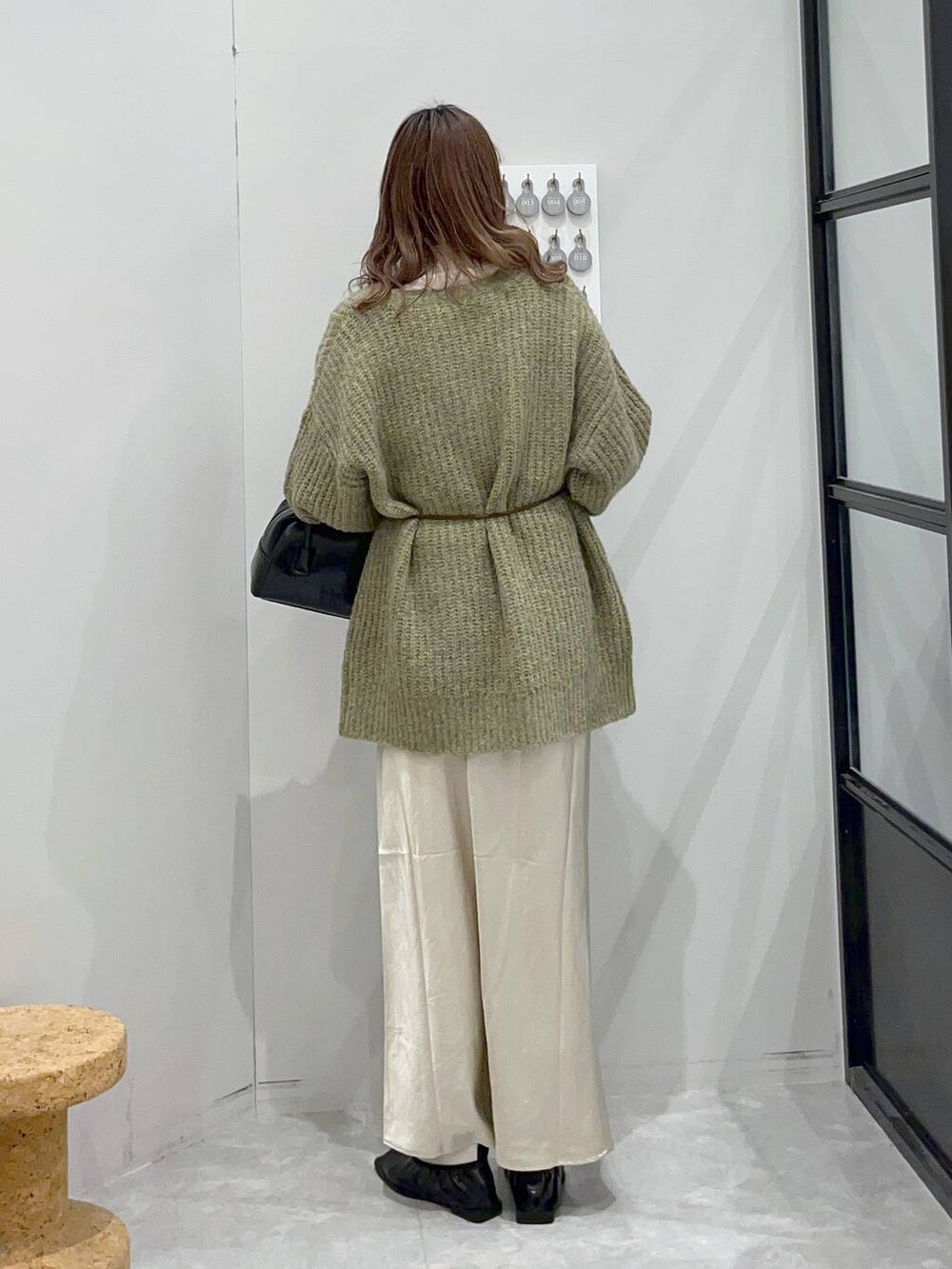 ホワイト系のスカート、ブラック系のボストンバッグ、ホワイト系のTシャツ/カットソーを着用したレディースの秋コーディネートの4枚目の写真