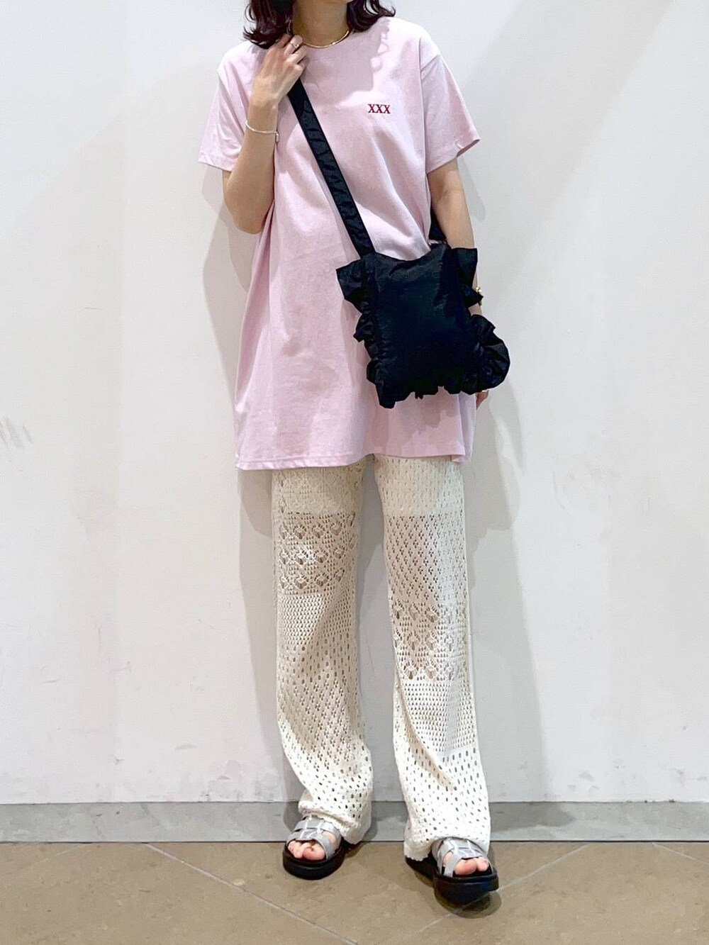 ホワイト系のその他パンツ、シルバー系のスニーカー、ブラック系のショルダーバッグを着用したレディースの夏コーディネートの2枚目の写真