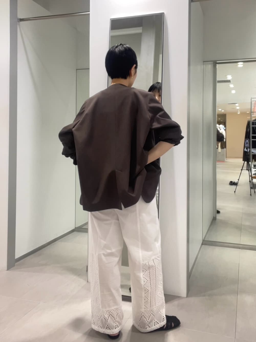 ブラック系のサンダル、ホワイト系のその他パンツ、ブラウン系のノーカラージャケットを着用したレディースの春コーディネートの2枚目の写真