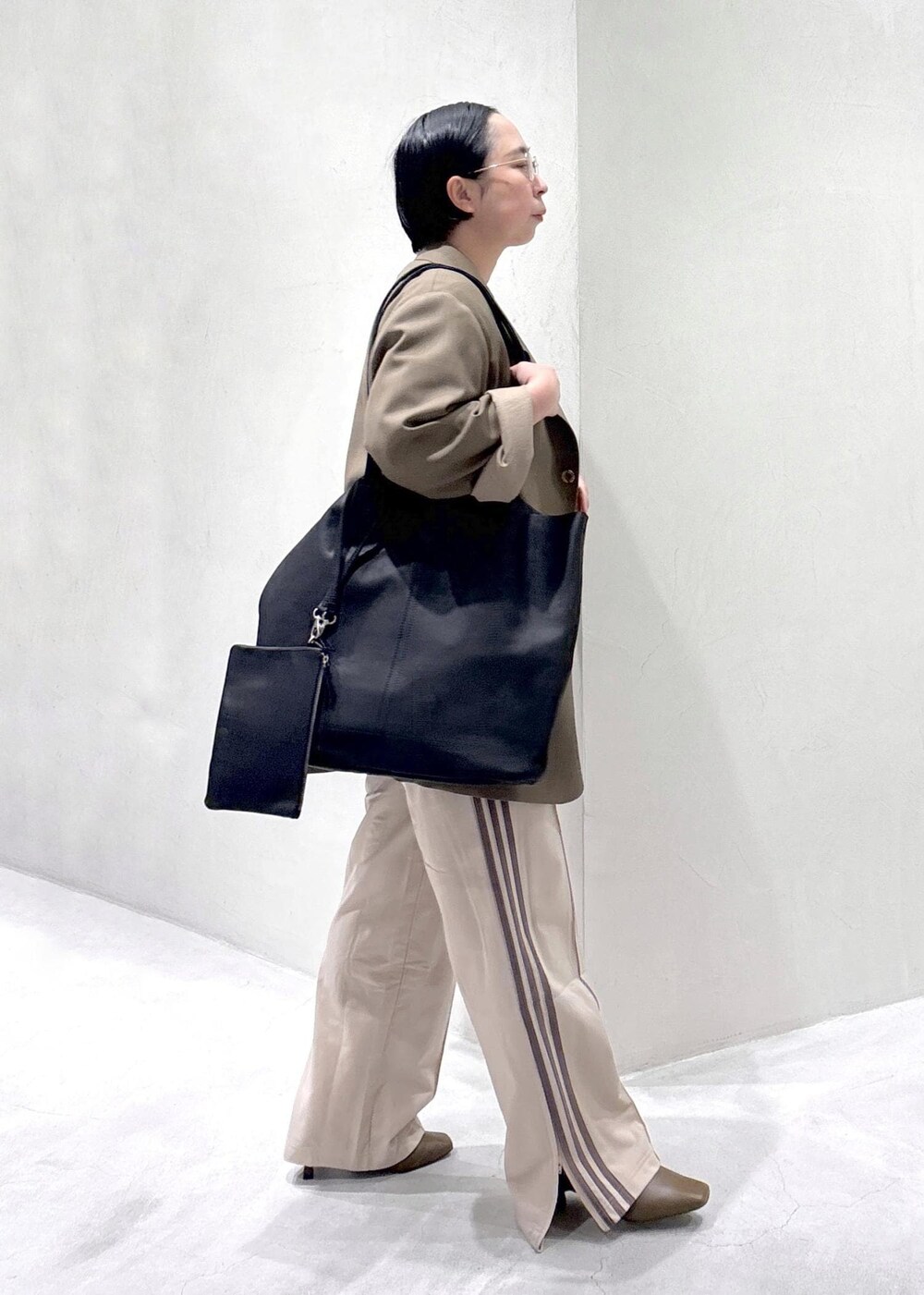 ブラウン系のパンプス、ホワイト系のTシャツ/カットソー、ベージュ系のその他パンツを着用したレディースの冬コーディネートの3枚目の写真