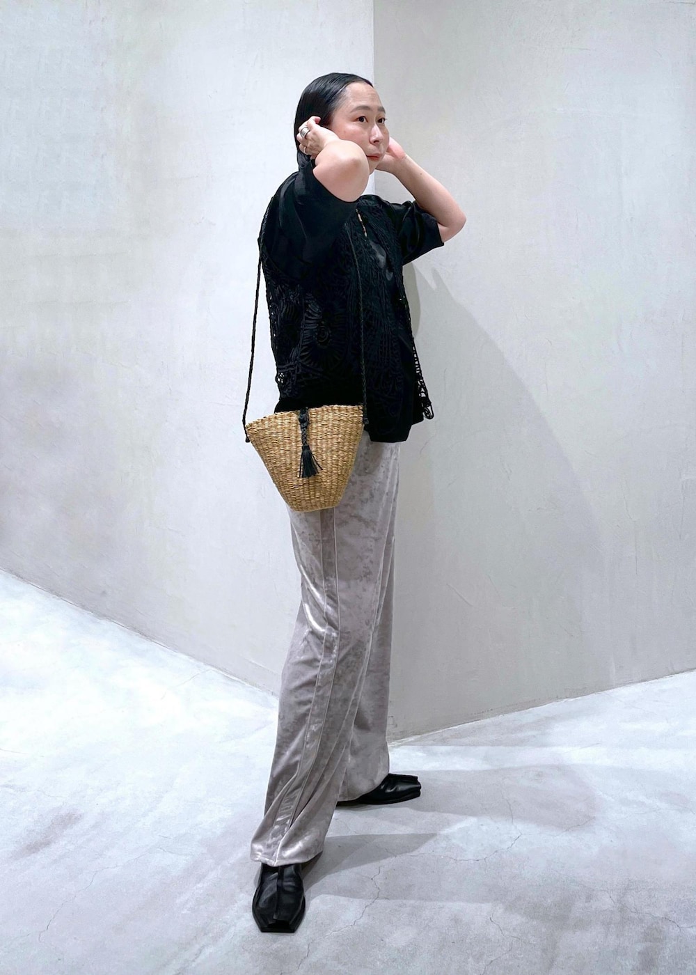 ベージュ系のかごバッグ、ブラック系のベスト、ベージュ系のその他パンツを着用したレディースの夏コーディネートの4枚目の写真