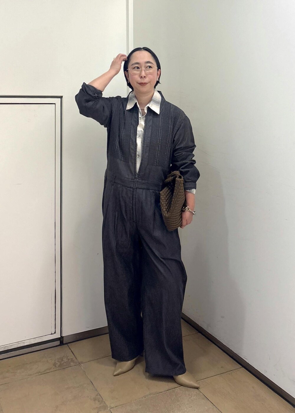 ベージュ系のパンプス、ブルー系のシャツ/ブラウス、イエロー系のトートバッグを着用したレディースの春コーディネートの3枚目の写真