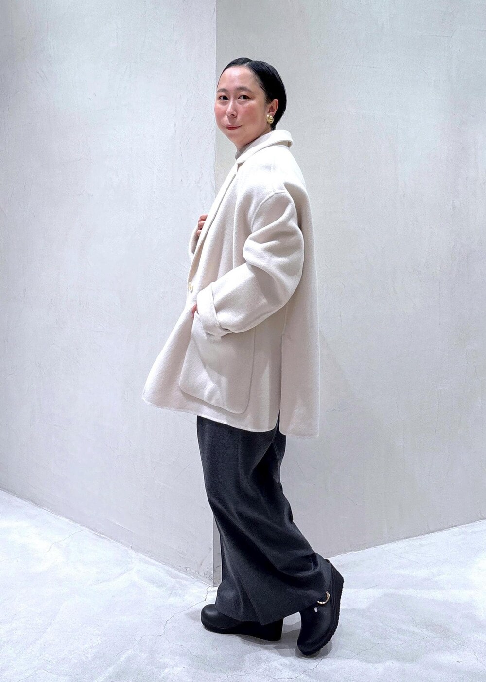 グレー系のスラックス、ブラック系のスカート、グレー系のシャツ/ブラウスを着用したレディースの秋コーディネートの6枚目の写真