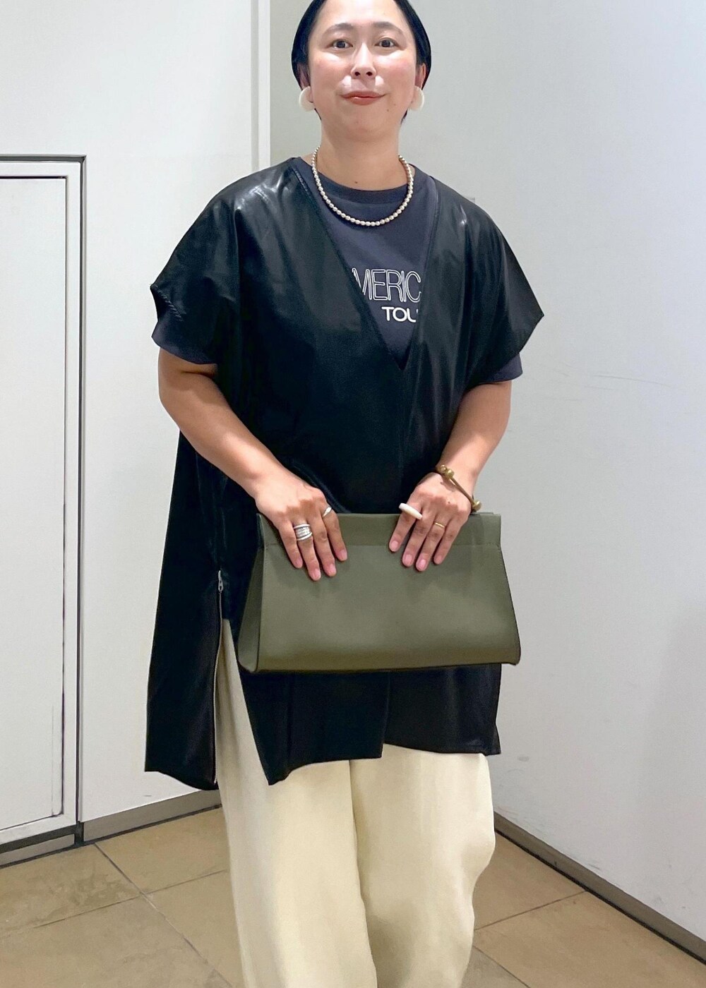 グリーン系のショルダーバッグ、ブラック系のTシャツ/カットソー、ホワイト系のスウェットパンツを着用したレディースの夏コーディネートの8枚目の写真