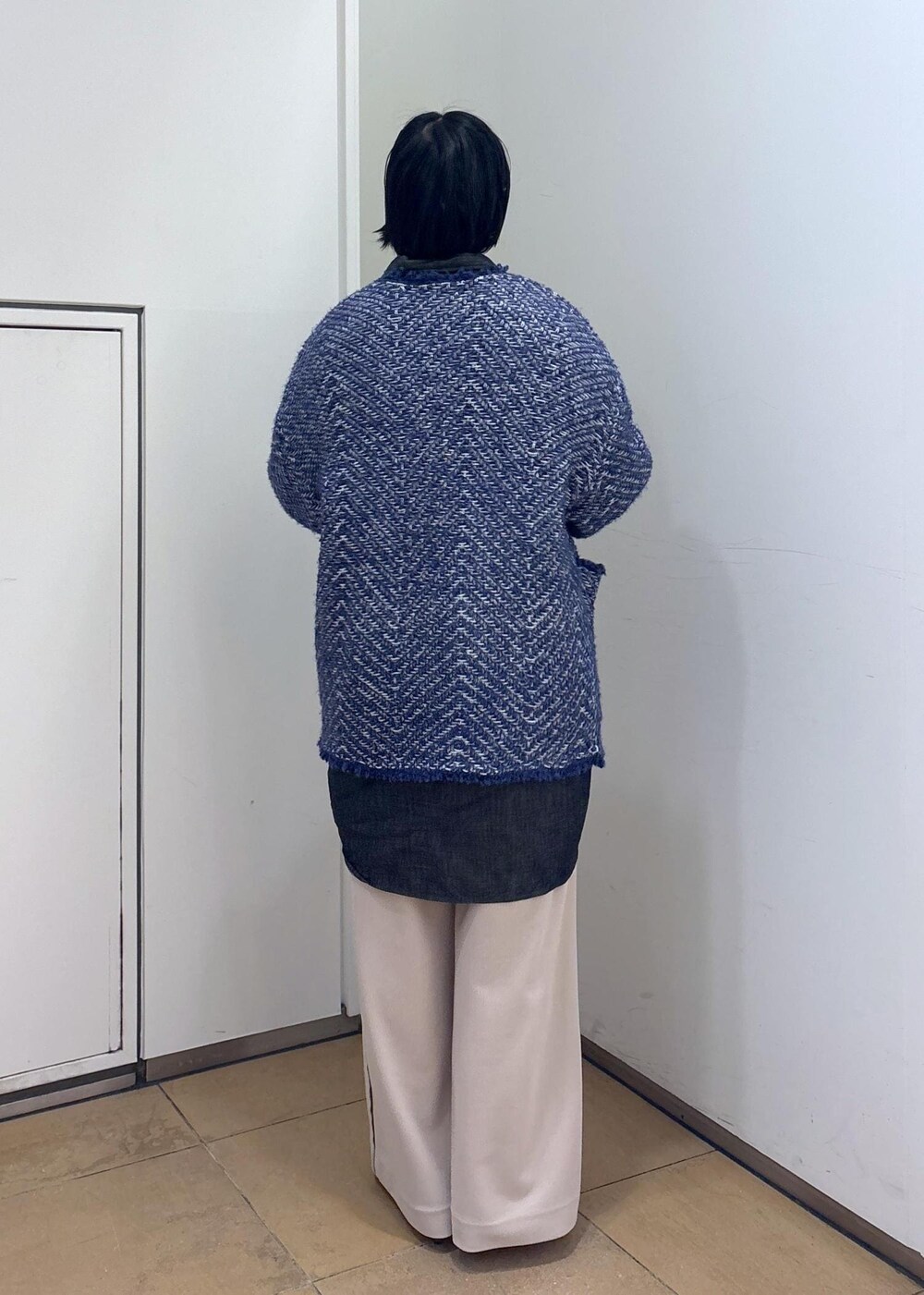 ブルー系のカーディガン/ボレロ、ブラウン系のショルダーバッグ、ホワイト系のその他パンツを着用したレディースの冬コーディネートの6枚目の写真