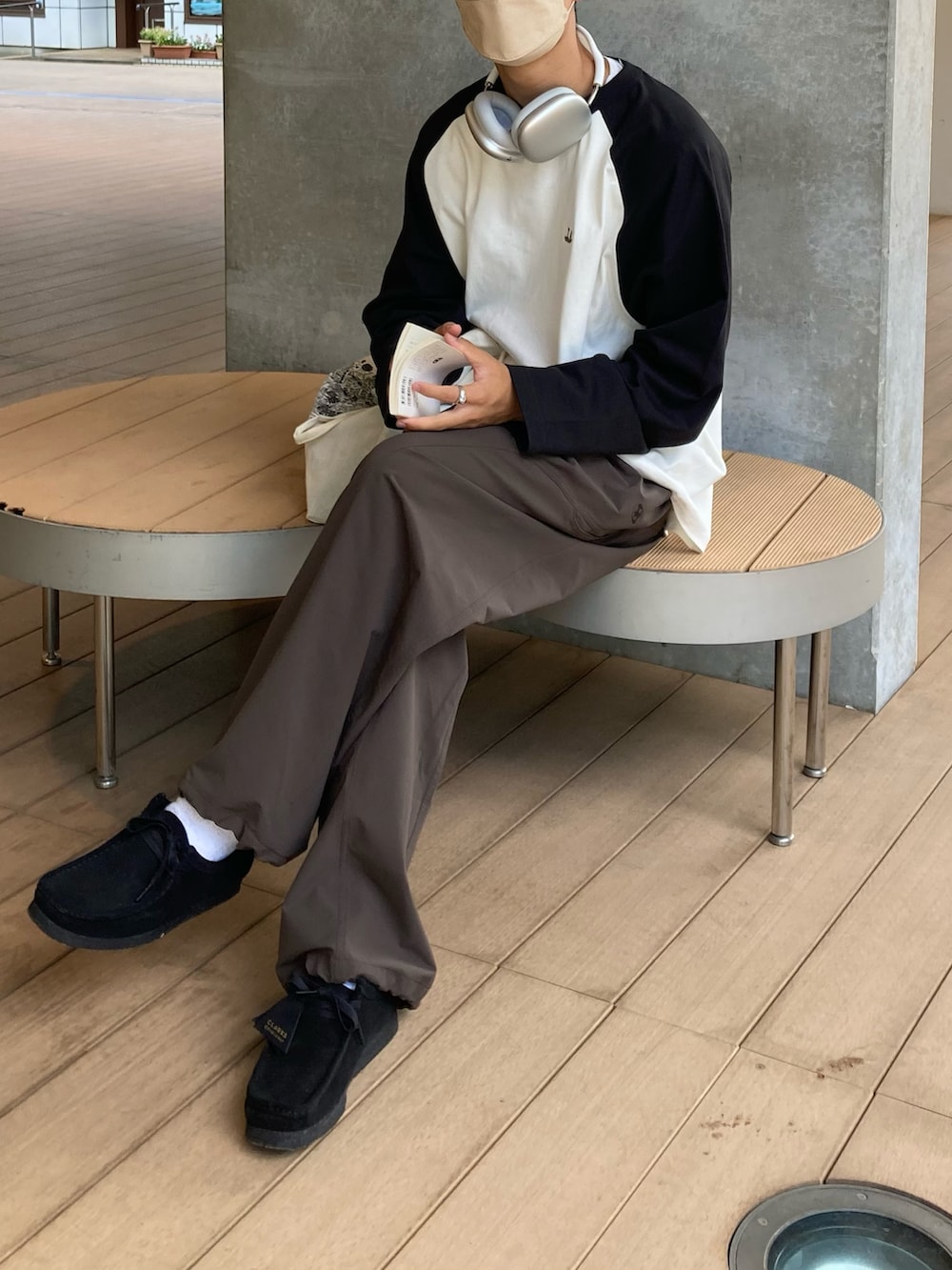 ホワイト系のTシャツ/カットソー、ブラウン系のカーゴパンツ、ブラック系のモカシン/デッキシューズを着用したメンズの秋コーディネートの3枚目の写真