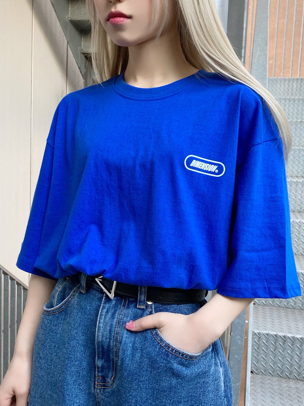 ブルー系のデニムパンツ、ブルー系のTシャツ/カットソー、ホワイト系のスニーカーを着用したレディースの春コーディネートの2枚目の写真