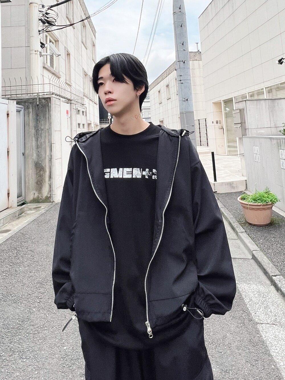 ホワイト系のスニーカー、ブラック系のカーゴパンツ、ブラック系のブルゾンを着用したメンズの秋コーディネートの2枚目の写真