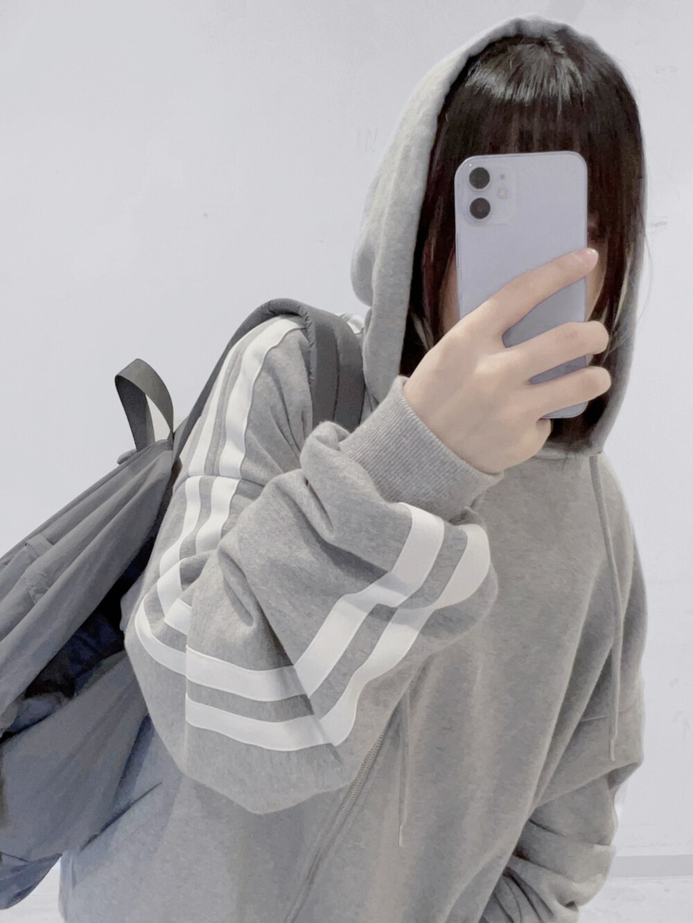 グレー系のバックパック/リュック、グレー系のパーカー、ブラック系のスカートを着用したレディースの秋コーディネートの2枚目の写真