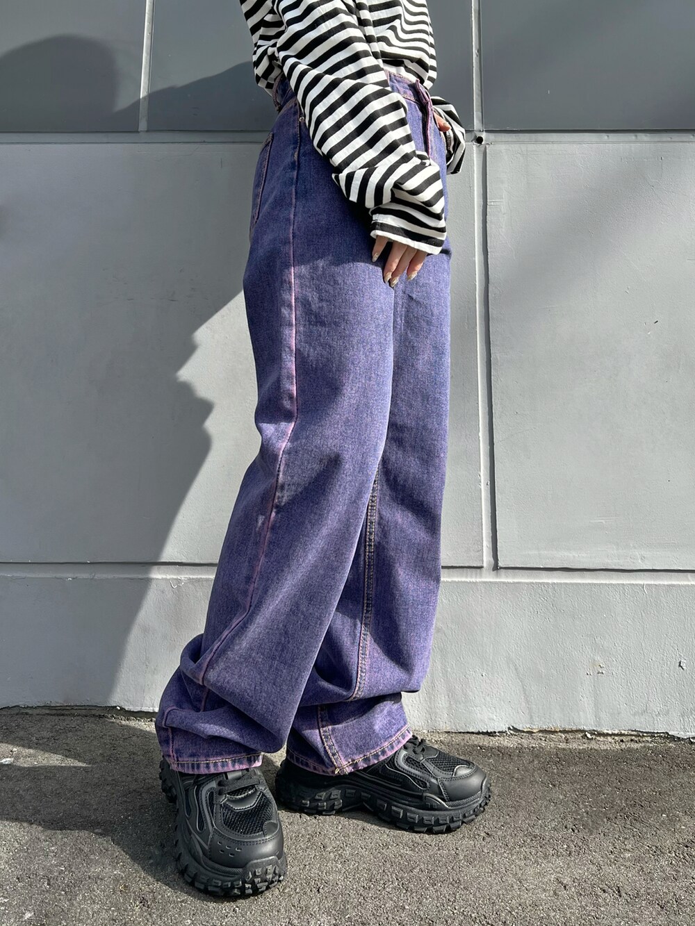 ホワイト系のTシャツ/カットソー、ブラック系のダウンベスト、ブラック系のスニーカーを着用したレディースの冬コーディネートの4枚目の写真