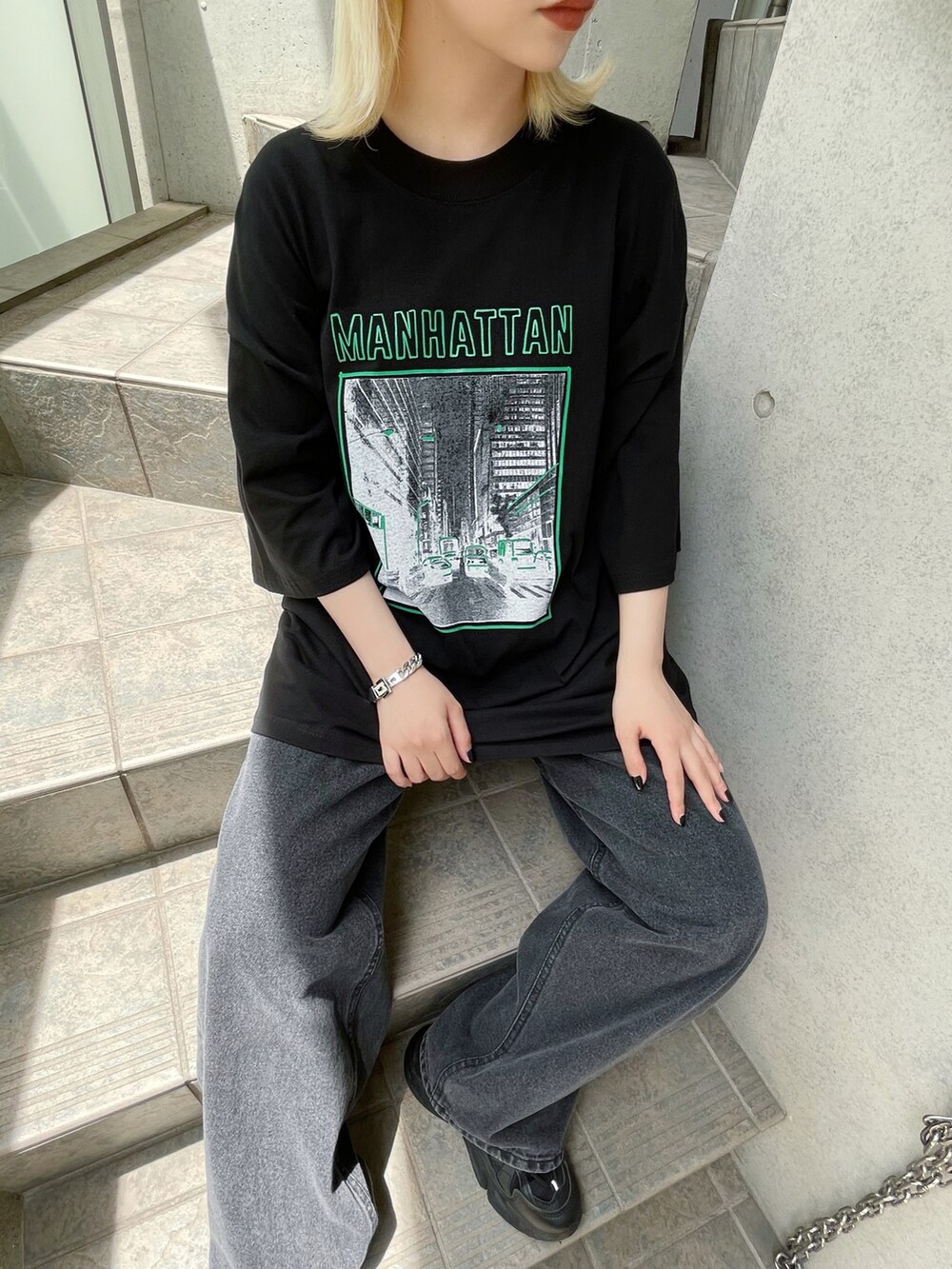 ブラック系のデニムパンツ、ブラック系のスニーカー、ブラック系のTシャツ/カットソーを着用したレディースの夏コーディネートの2枚目の写真