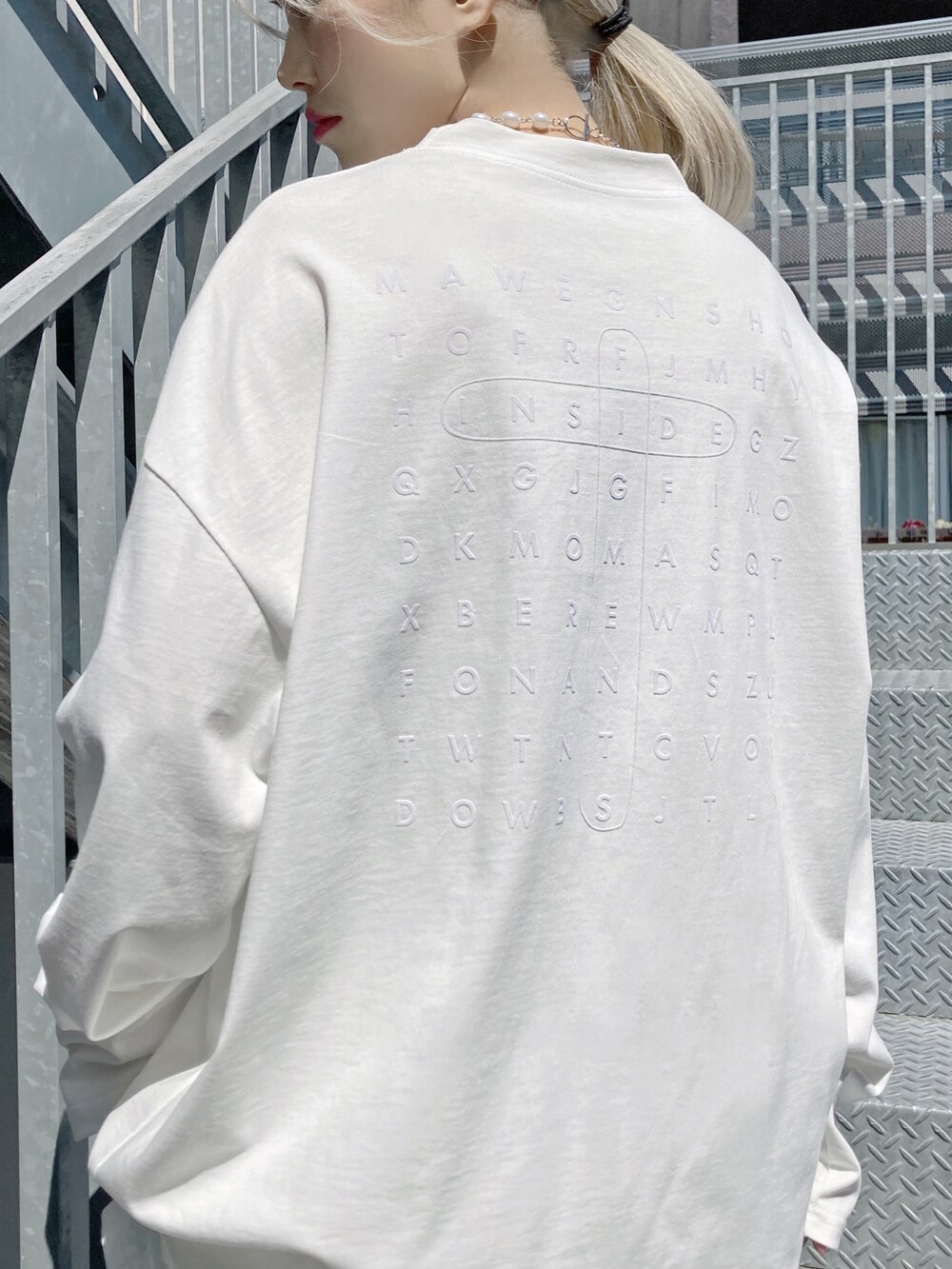 ホワイト系のTシャツ/カットソー、ホワイト系のスカート、ホワイト系のスニーカーを着用したレディースの春コーディネートの2枚目の写真