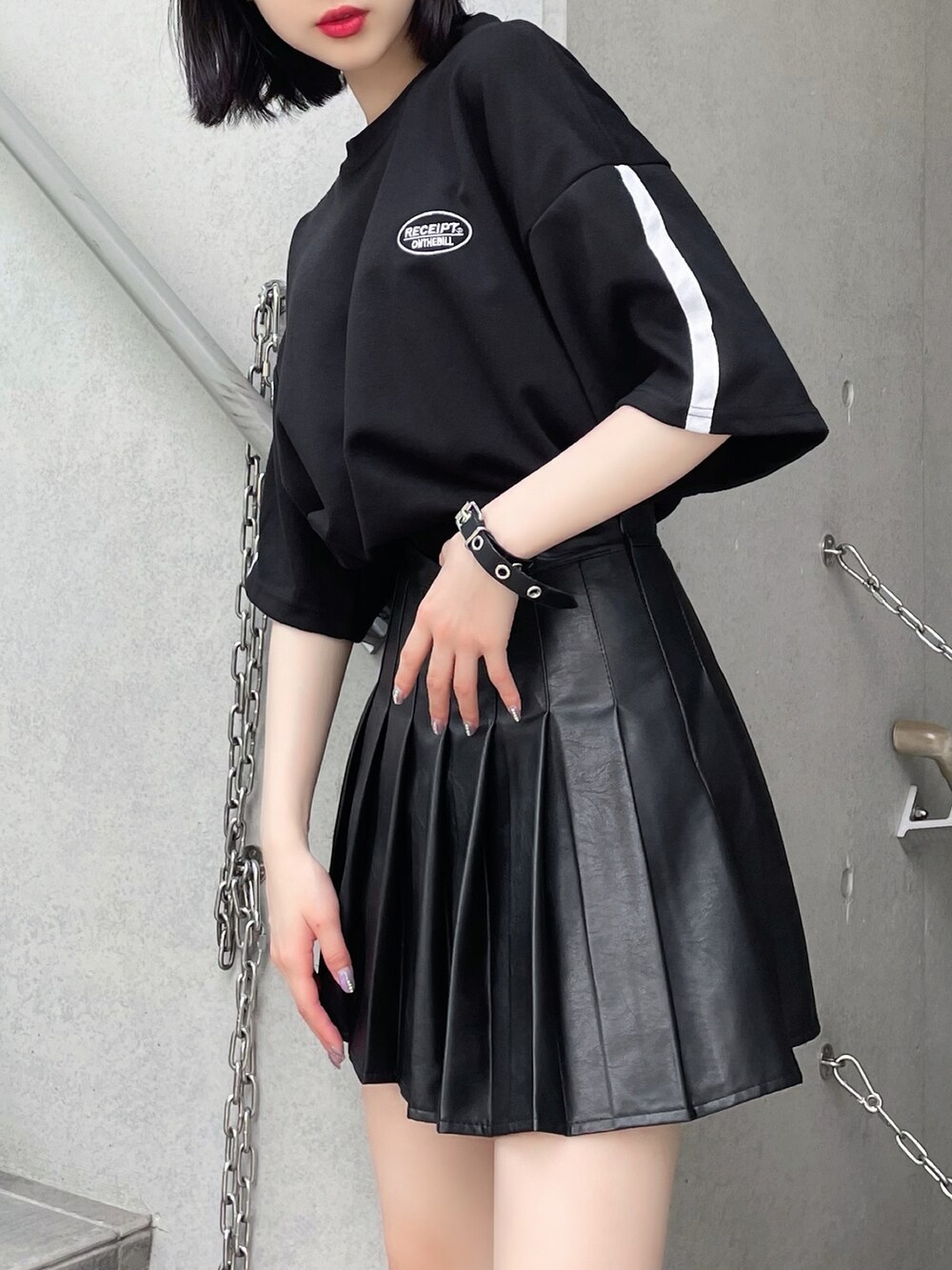 ブラック系のスカート、ブラック系のTシャツ/カットソー、ブラック系のブーツを着用したレディースの夏コーディネートの2枚目の写真