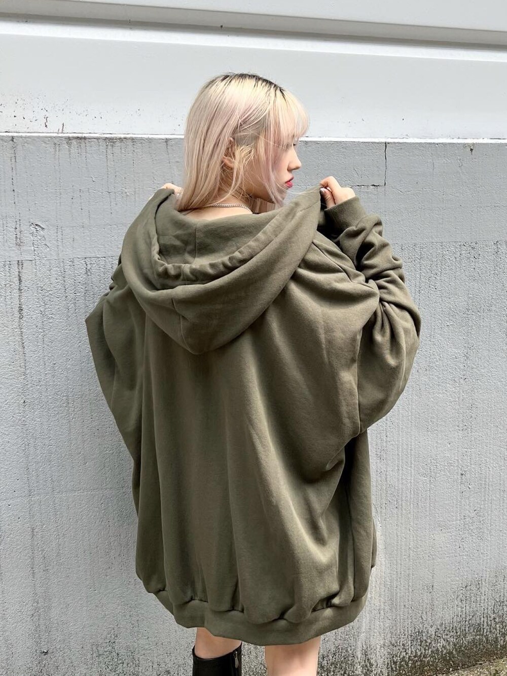 ブラック系のスカート、ブラック系のTシャツ/カットソー、ブラック系のブーツを着用したレディースの秋コーディネートの2枚目の写真