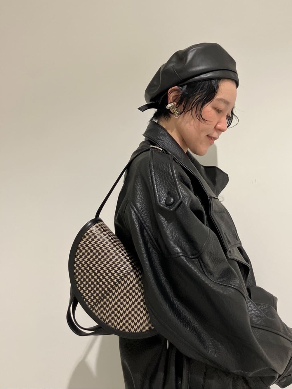 ベージュ系のショルダーバッグを着用したレディースの秋コーディネートの2枚目の写真