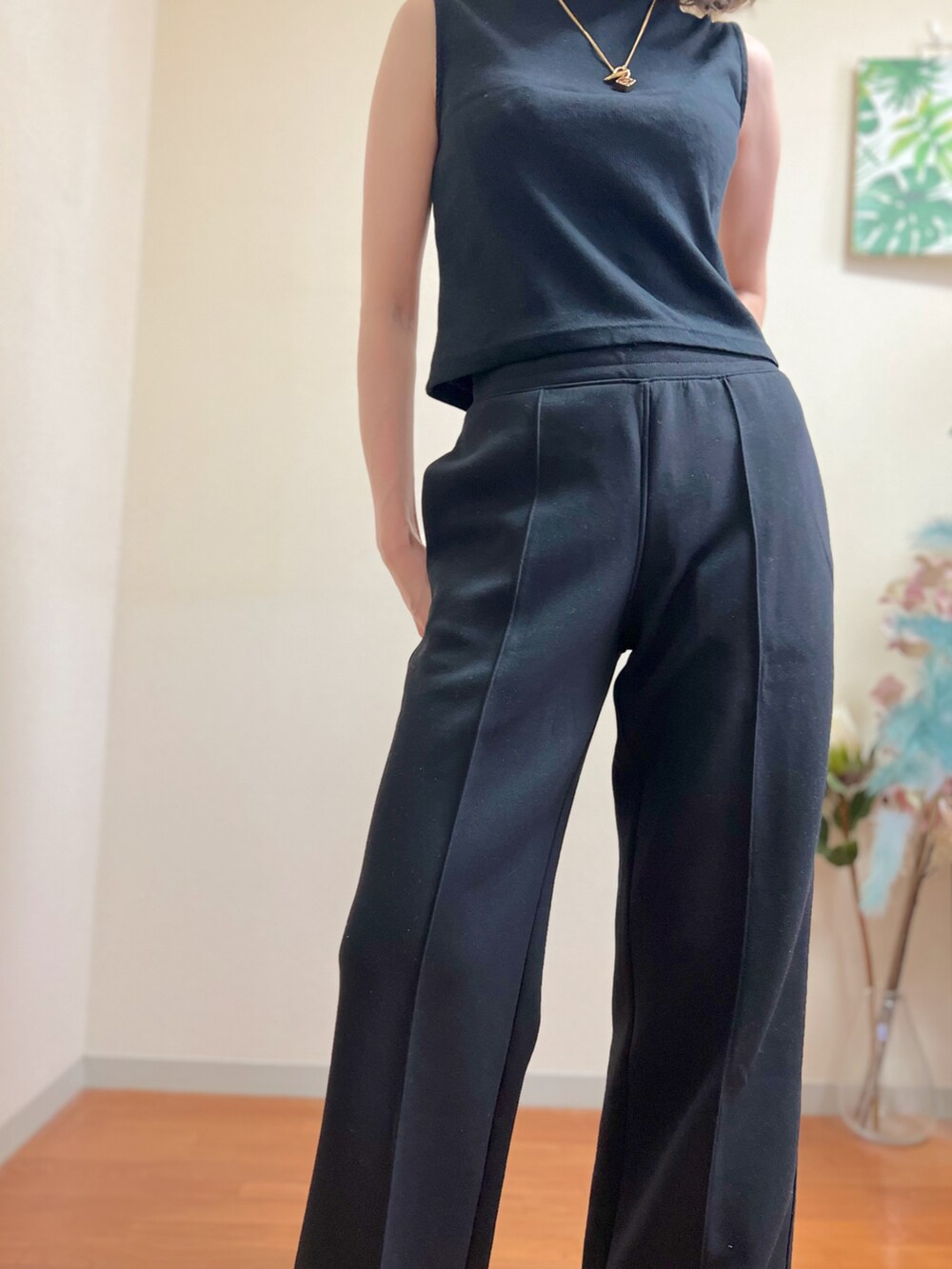 ブラック系のタンクトップ、ブラック系のサンダル、ブラック系のパンツを着用したレディースの夏コーディネートの4枚目の写真