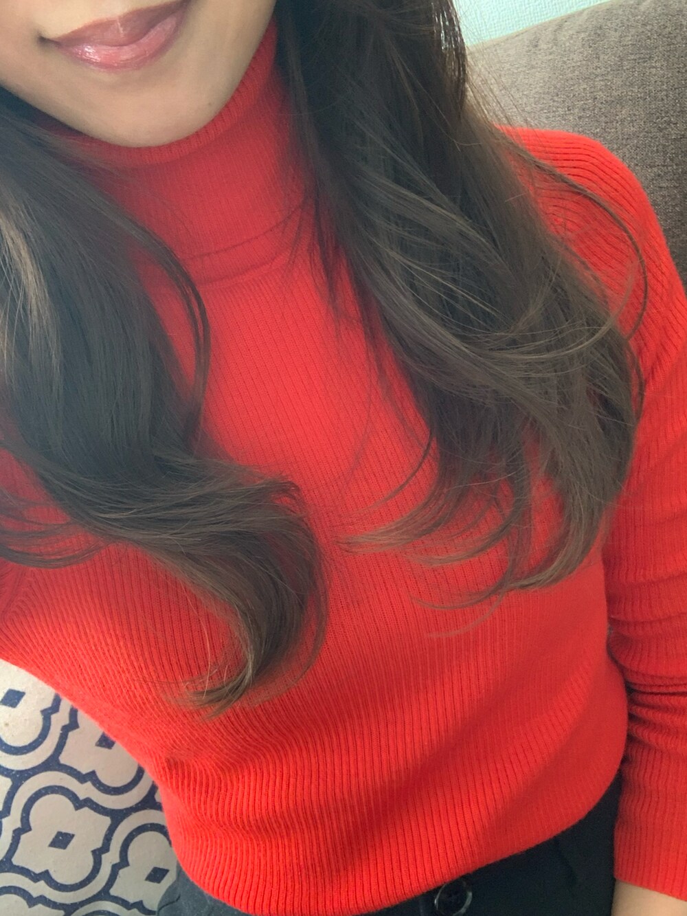 レッド系のニット/セーター、ホワイト系のジャケット/アウターを着用したレディースの冬コーディネートの2枚目の写真