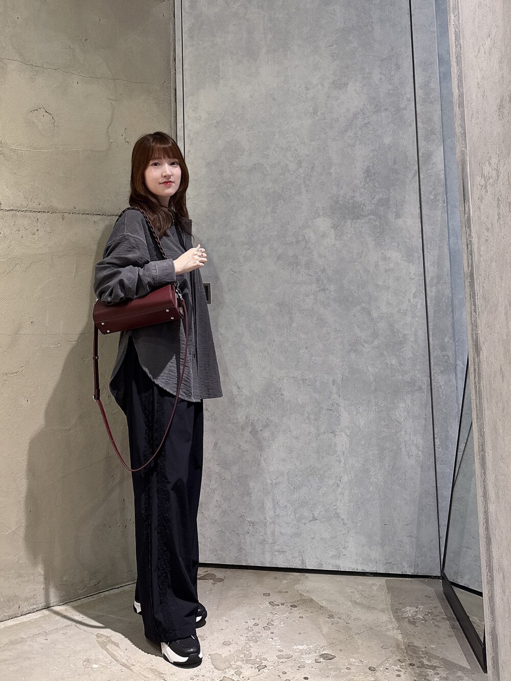 ブラック系のシャツ/ブラウス、レッド系のショルダーバッグを着用したレディースの夏コーディネートの2枚目の写真