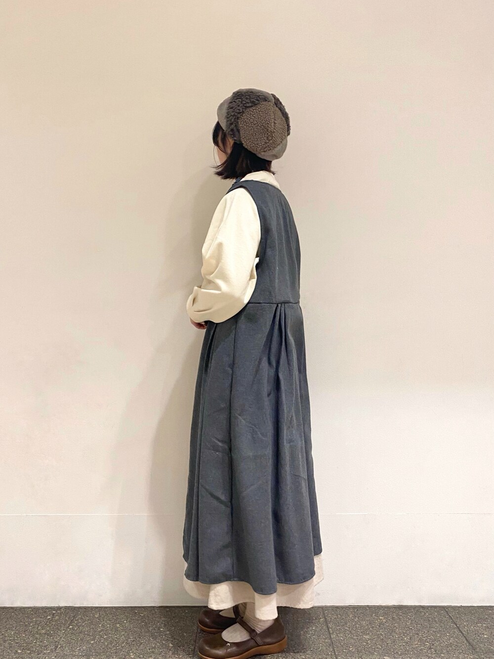 グリーン系のTシャツ/カットソー、ホワイト系のTシャツ/カットソー、グレー系のワンピースを着用したレディースの冬コーディネートの2枚目の写真