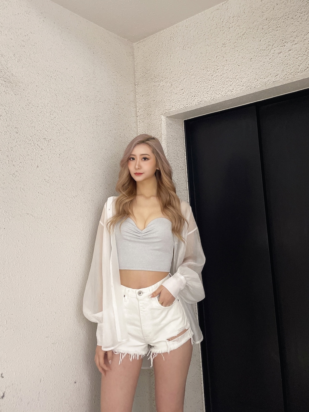 ホワイト系のデニムパンツ、シルバー系のチューブトップ、ホワイト系のシャツ/ブラウスを着用したレディースの春コーディネートの4枚目の写真