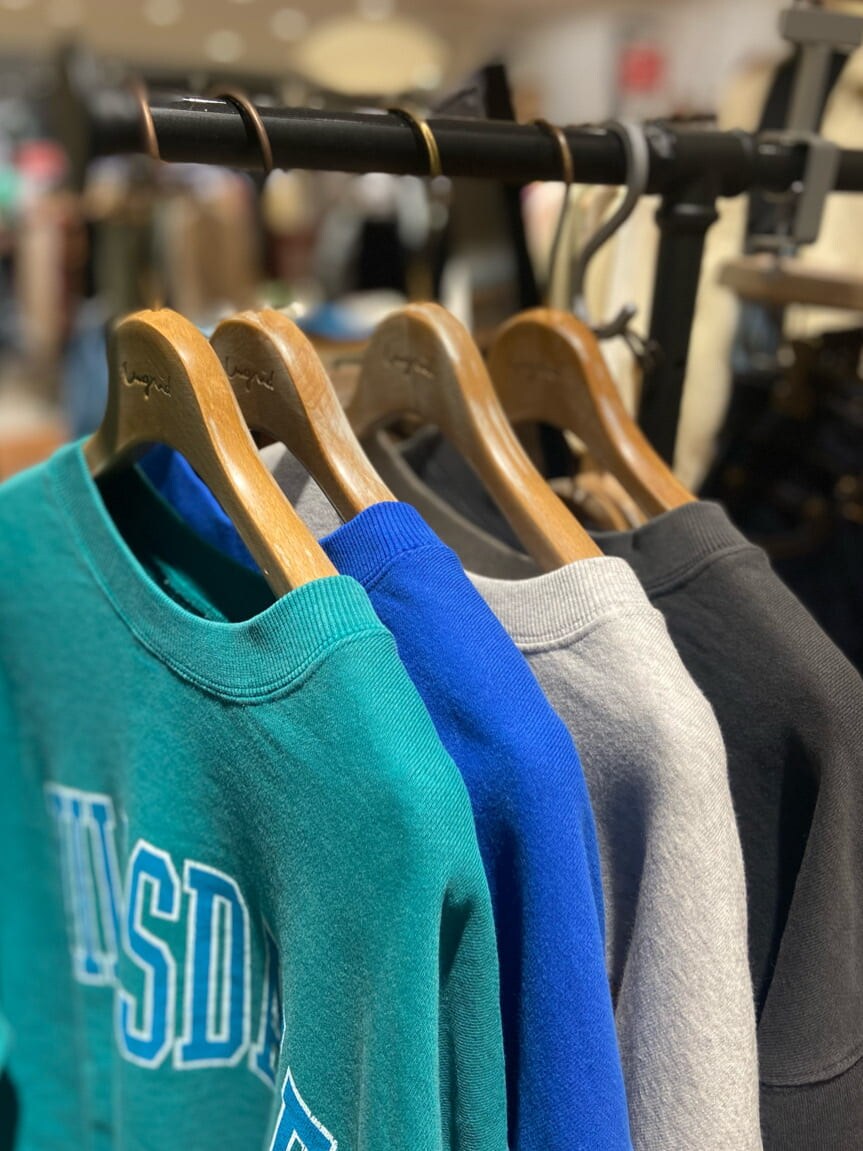 グリーン系のスウェット、ホワイト系のデニムパンツ、ホワイト系のショルダーバッグを着用したレディースの冬コーディネートの3枚目の写真