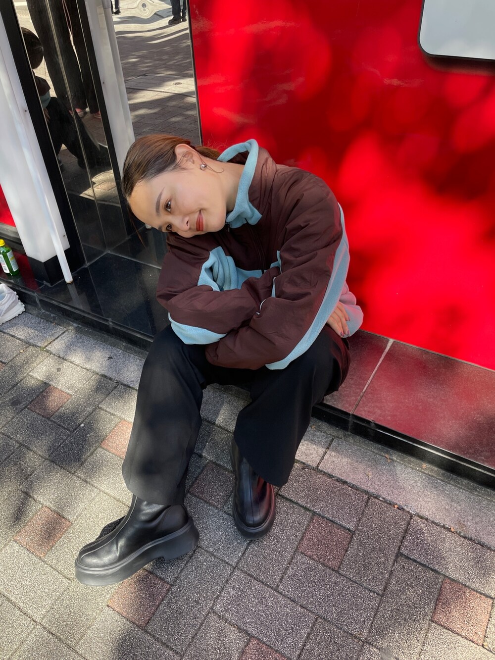 ブルー系のブルゾン、ブラック系のブーツを着用したレディースの秋コーディネートの2枚目の写真