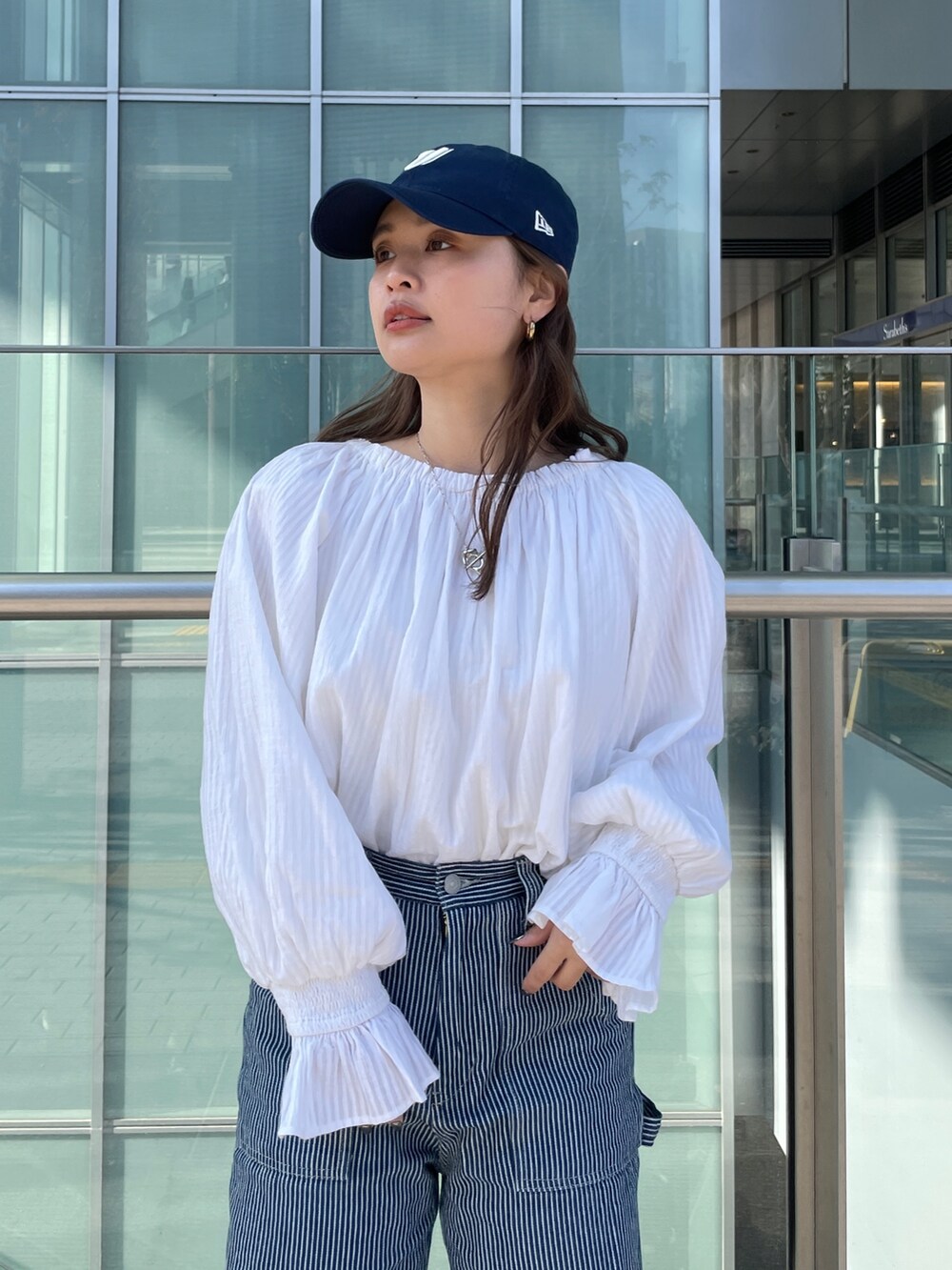 その他のデニムパンツ、ホワイト系のシャツ/ブラウス、ブラック系のキャップを着用したレディースの冬コーディネートの3枚目の写真