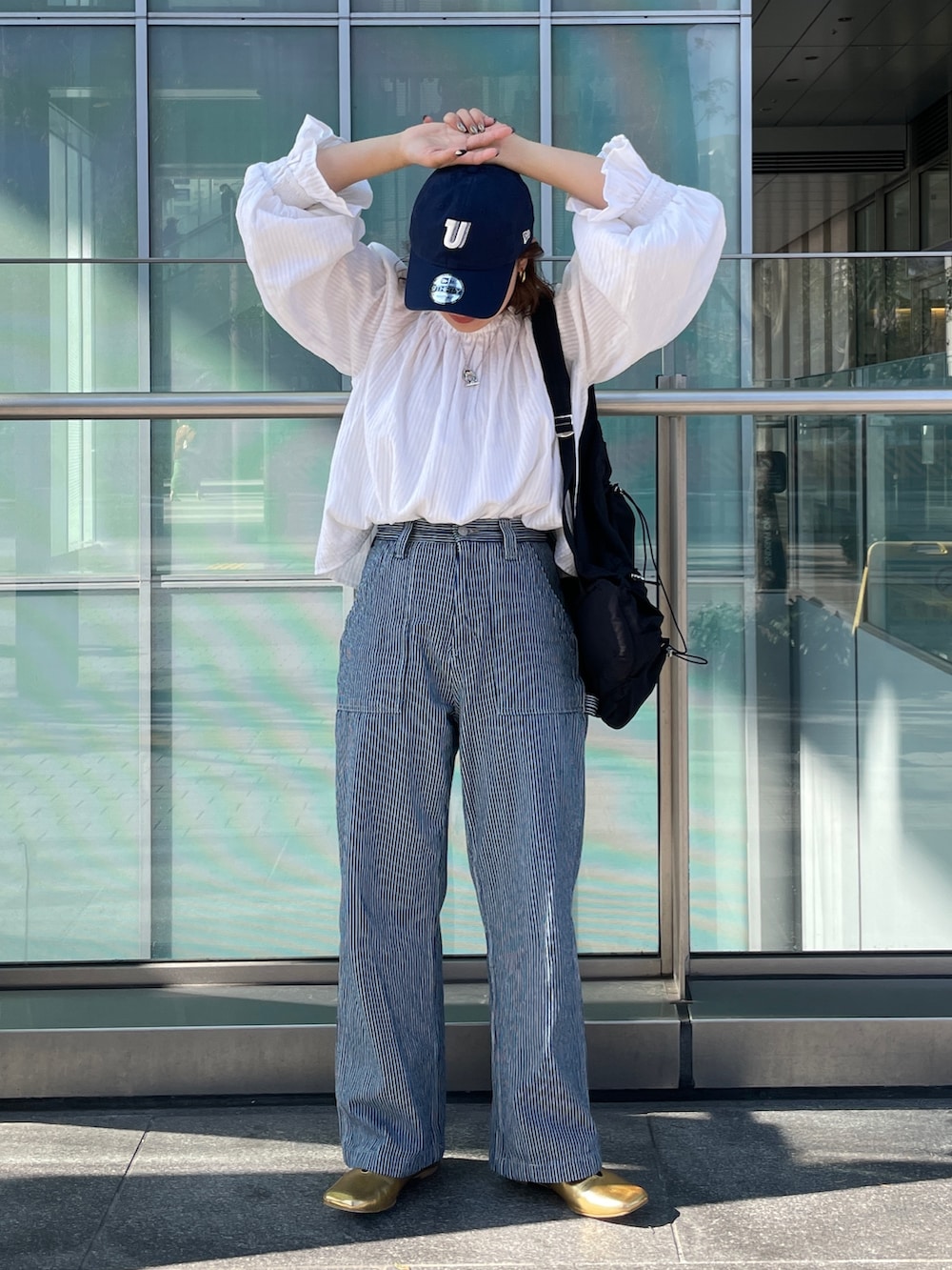 その他のデニムパンツ、ホワイト系のシャツ/ブラウス、ブラック系のキャップを着用したレディースの冬コーディネートの2枚目の写真