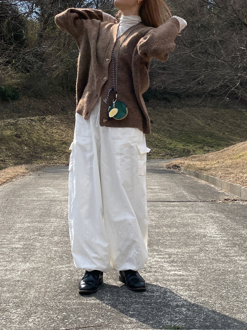 ホワイト系のカーゴパンツ、ブラウン系のカーディガン/ボレロを着用したレディースの冬コーディネートの4枚目の写真