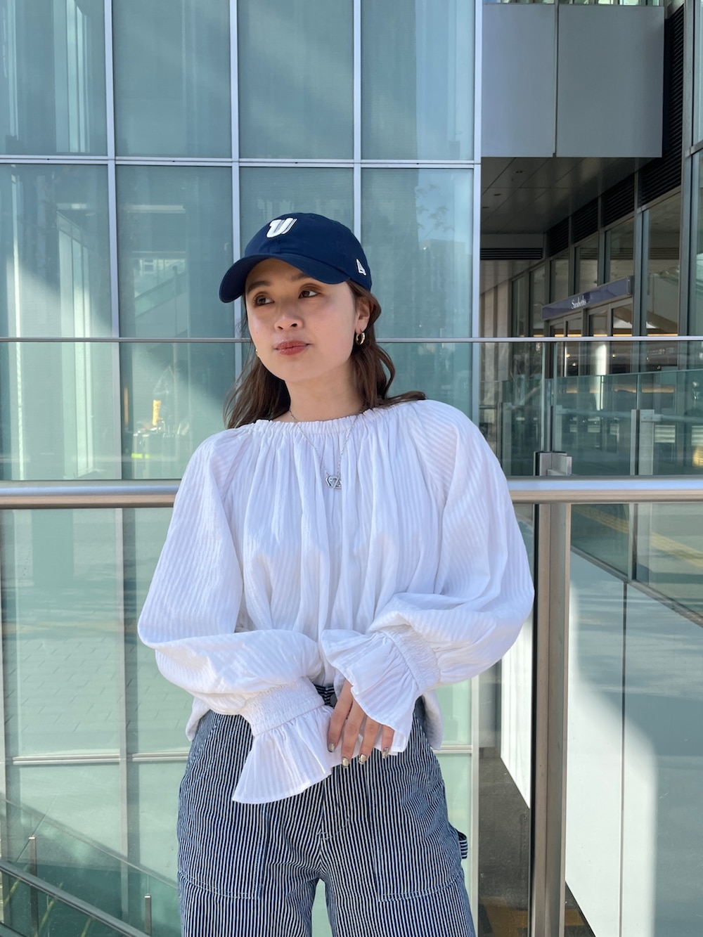 その他のデニムパンツ、ホワイト系のシャツ/ブラウス、ブラック系のキャップを着用したレディースの冬コーディネートの7枚目の写真