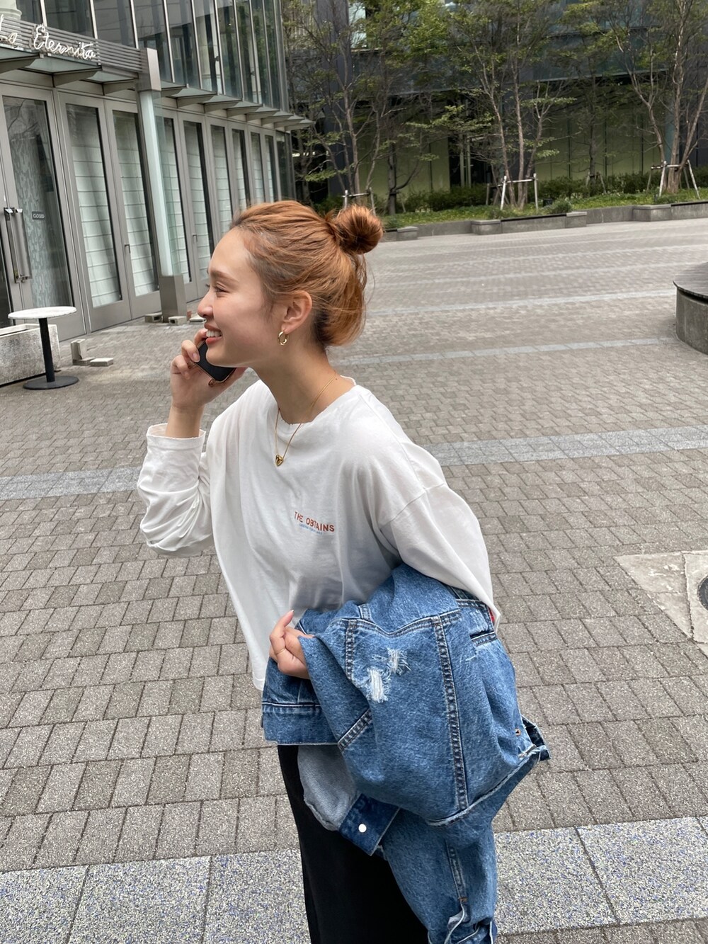 ブルー系のデニムジャケット、ブラウン系のワンピース、ホワイト系のTシャツ/カットソーを着用したレディースの春コーディネートの5枚目の写真