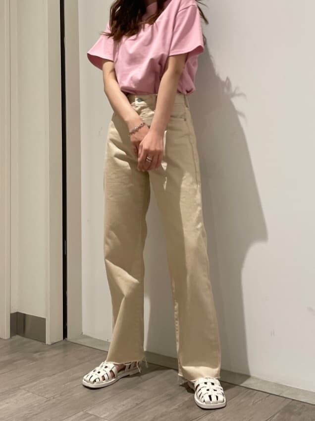 ホワイト系のデニムパンツ、ホワイト系のサンダル、ピンク系のTシャツ/カットソーを着用したレディースの春コーディネートの3枚目の写真
