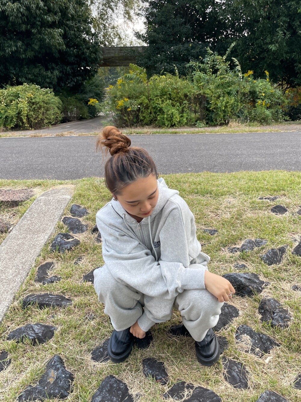 ブラック系のブーツ、グレー系のスウェットパンツ、グレー系のパーカーを着用したレディースの秋コーディネートの5枚目の写真