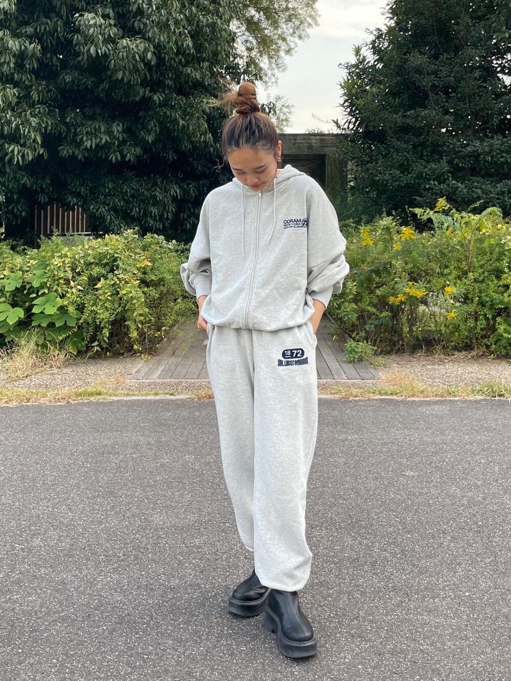 ブラック系のブーツ、グレー系のスウェットパンツ、グレー系のパーカーを着用したレディースの秋コーディネートの3枚目の写真