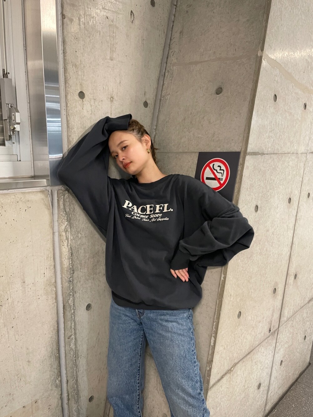 グレー系のスウェット、ブルー系のデニムパンツ、ホワイト系のスニーカーを着用したレディースの夏コーディネートの6枚目の写真